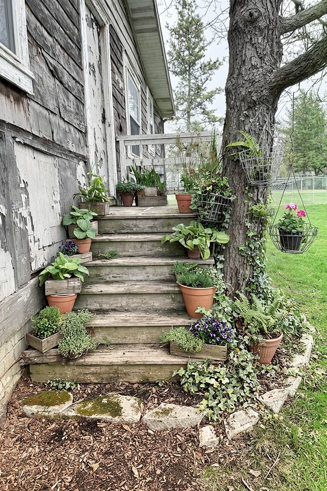 Cascading Potted Staircase in a Rustic Corner Garden