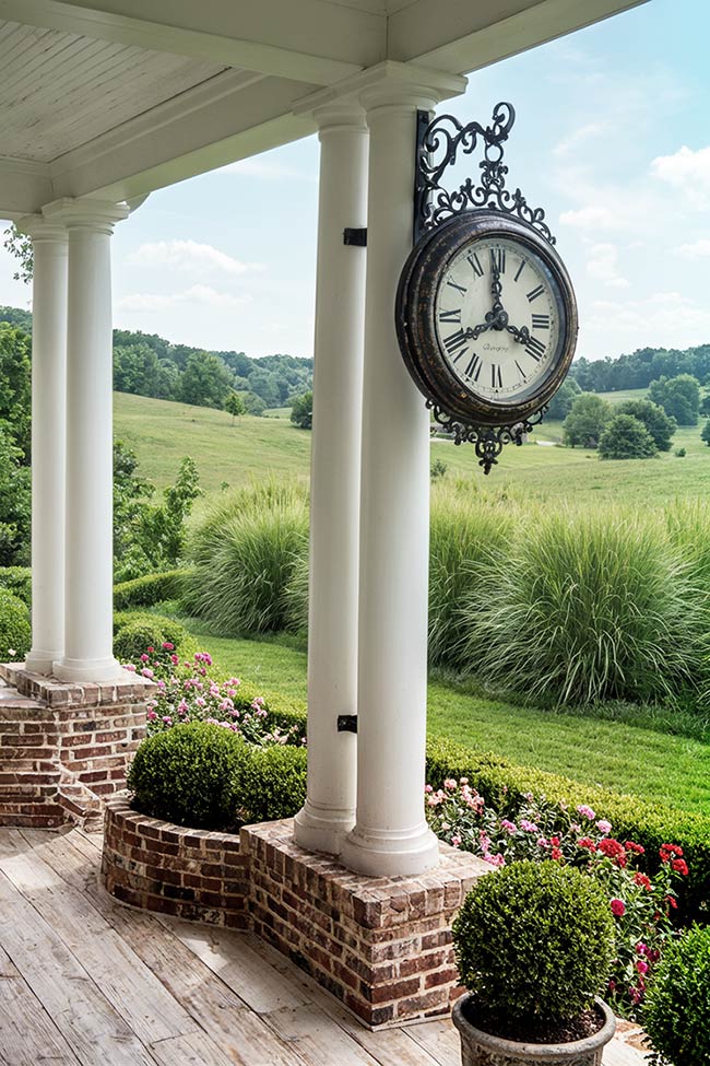 Timeless Elegance with a Hanging Station Clock Above the Entry Porch