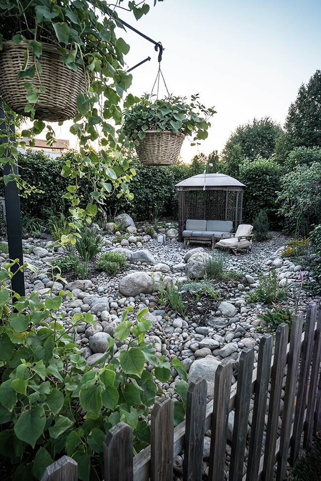 Hanging Greenery Over a Pebble-Filled Rock Garden